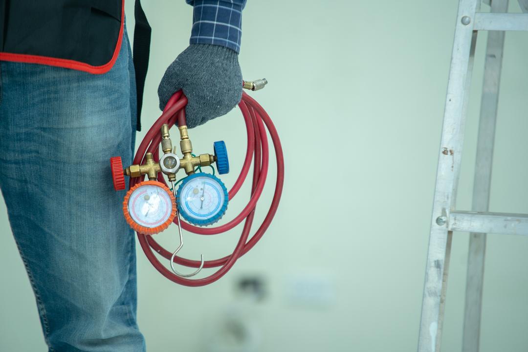 Technician holding manifold gauge