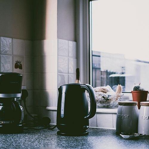 electric kettle on a countertop near a coffee pot