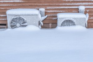 a heatpump outside of a home buried in snow